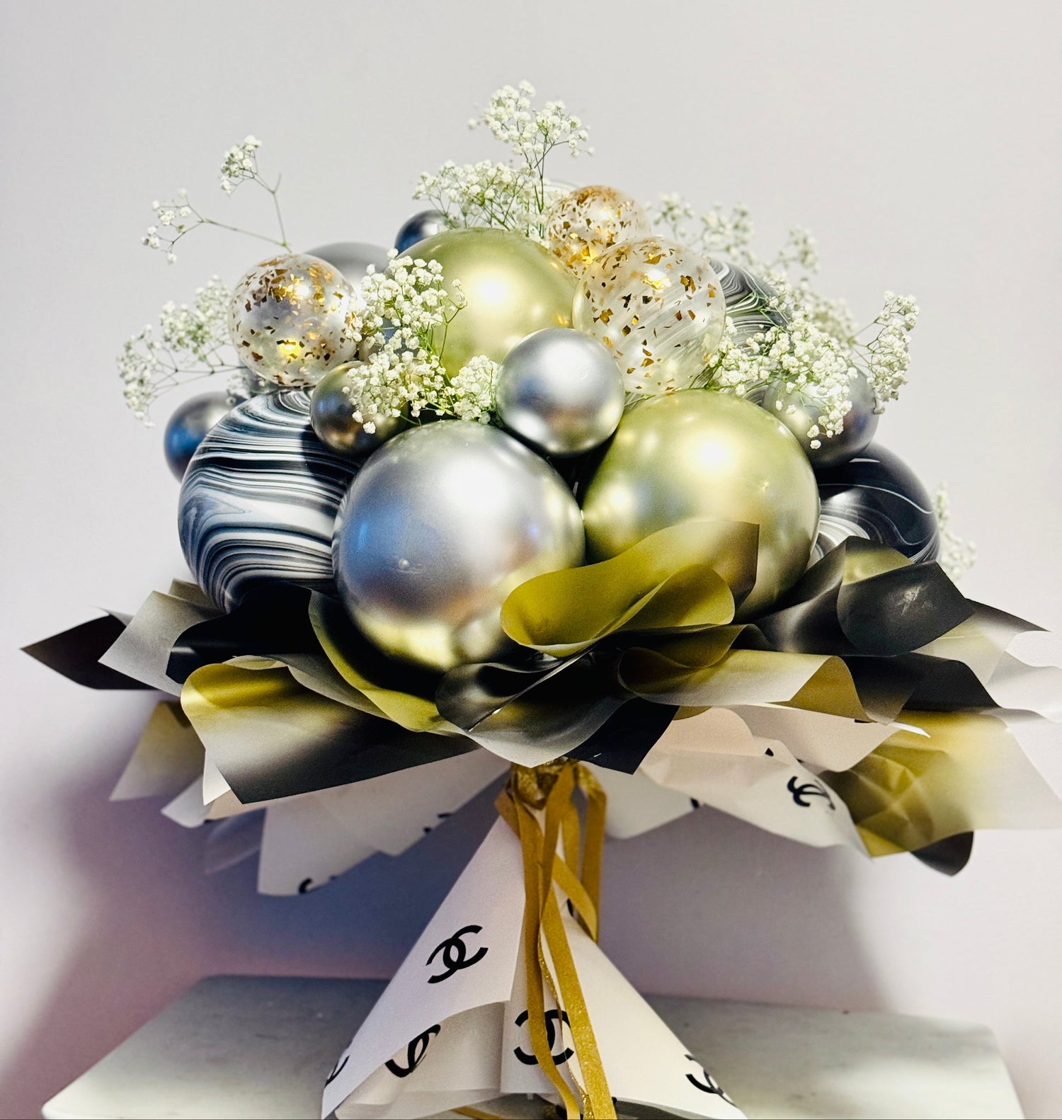 Decorative arrangement of ornaments and flowers with ribbons on a light background